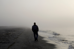 Lonely man walking on a beach